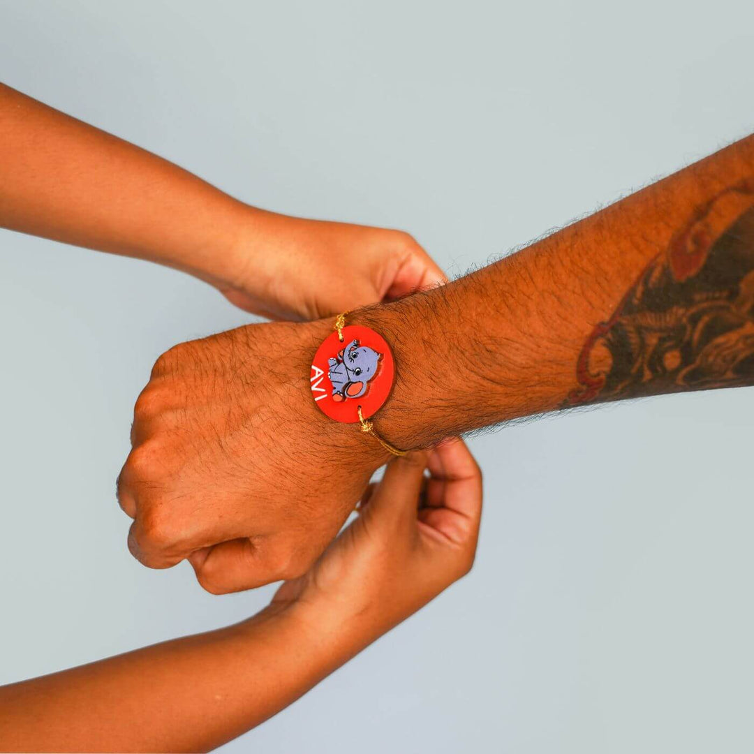 Handmade Personalized Rakhi Keychain With Roli Chawal 5 - Rakhi being tied on wrist