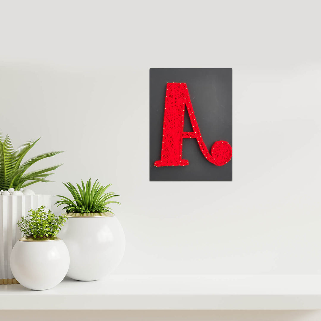 Personalised Alphabet String Art - Mounted on Wall with Plants Nearby