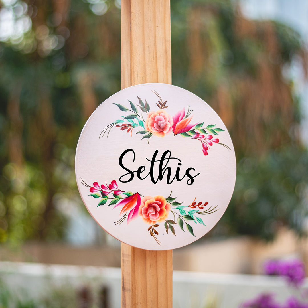 One Stroke Art Circular Name Plate With Family Name - Front View Mounted on Wood Post