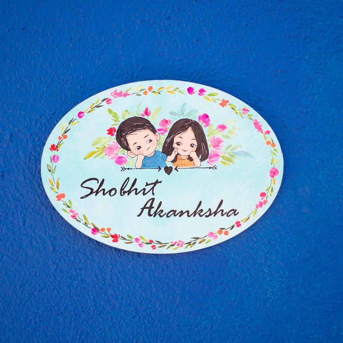 Oval Hand Painted Character Name Plate For Couple Teal Background - Front View on Blue Background